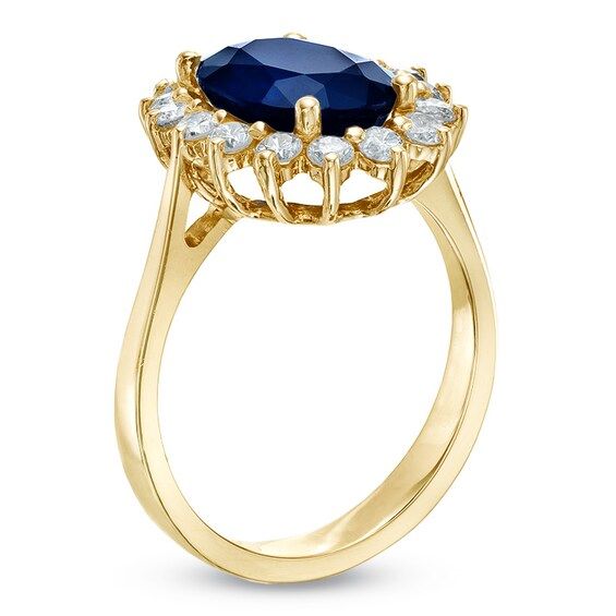 a gold ring with an oval blue stone surrounded by small white diamonds on the sides