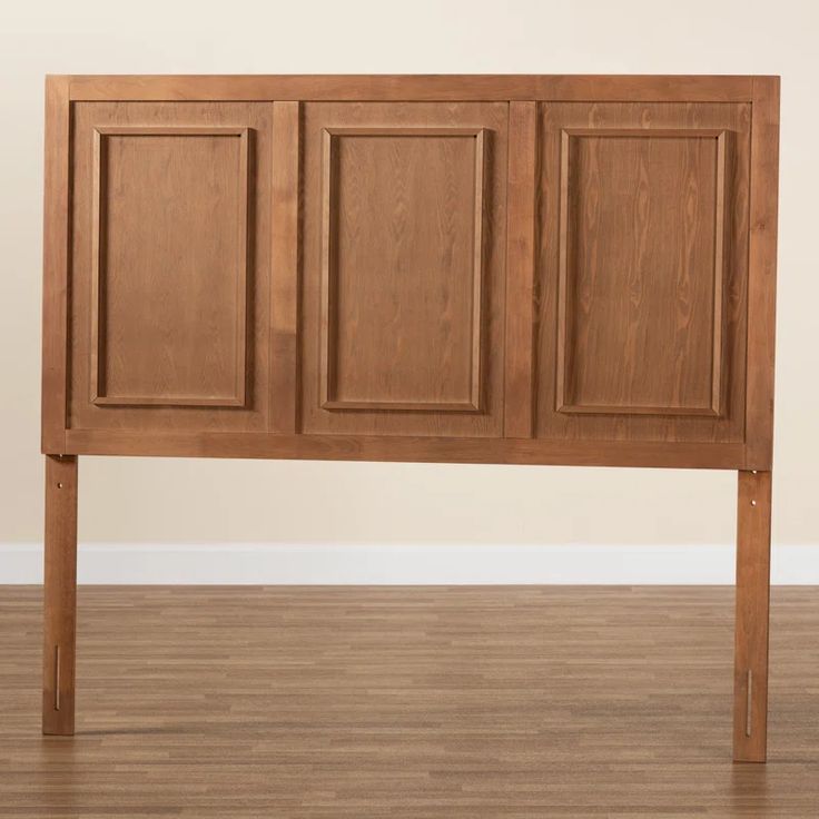 a wooden headboard with four paneled doors