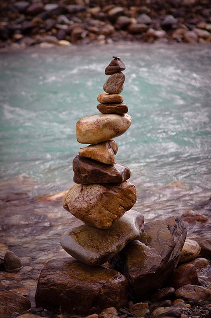 a stack of rocks sitting on top of a river