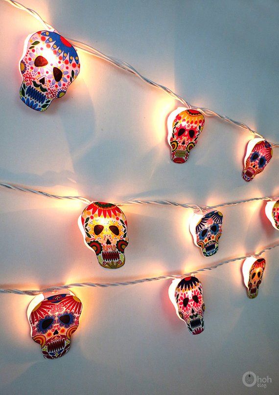 some lights that have skulls on them and are hanging from the string with strings in front of them