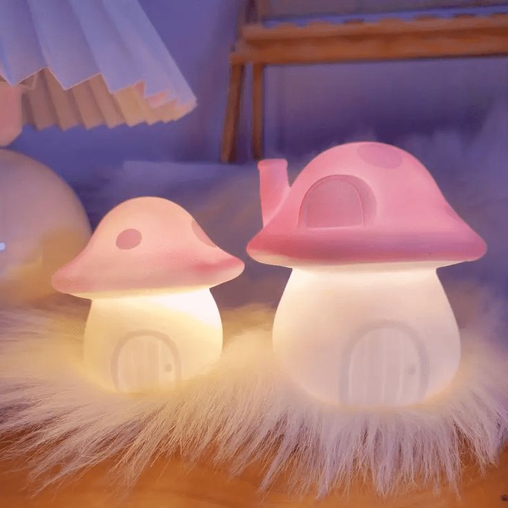 two mushroom shaped lights sitting on top of a table