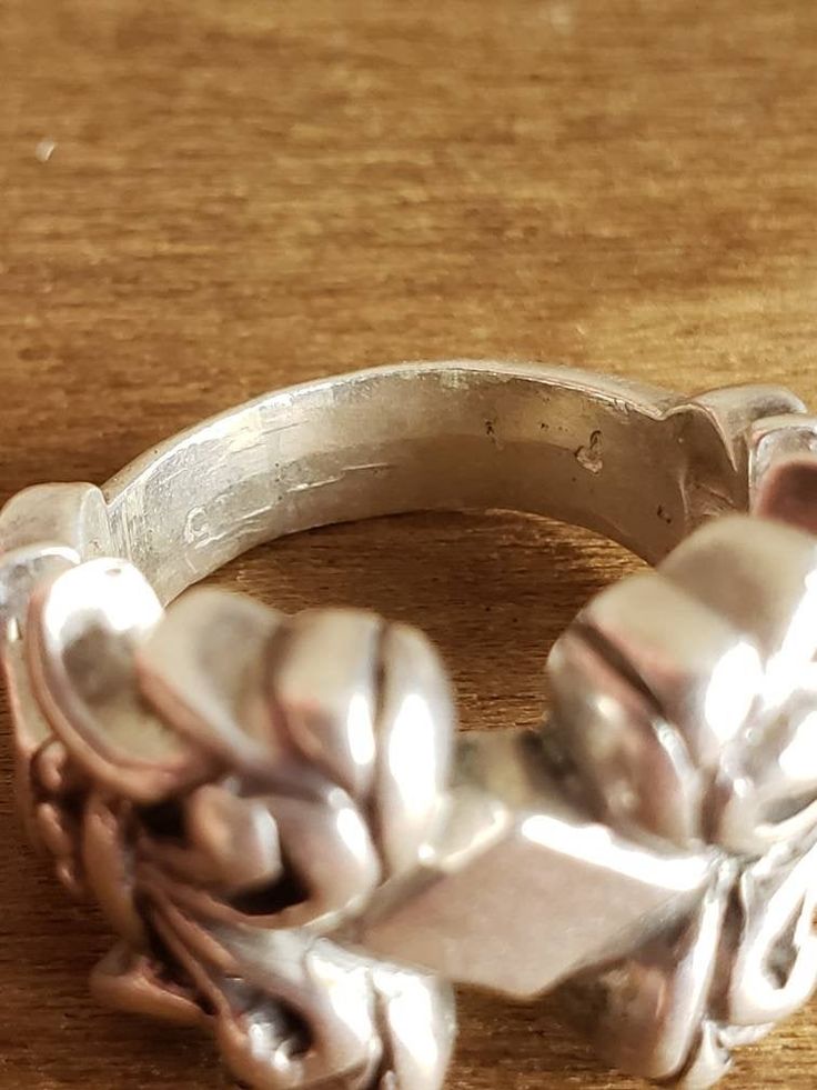 This is a vintage, sterling silver ring. It has been hammered on the bottom of the band. There is a lot of intricate detail on this ring. The ring has 925 (faintly) stamped on the bottom. This ring is from 1990 and is absolutely stunning. This ring measures as a size 4.75 and can be sized. Don't forget to stop in at my other Etsy shop... http://www.etsy.com/shop/xtdesigns. Follow me on Twitter at... MyYiayiaHadThat@MyYiayiaHadThat. If you have a wish list or are looking for something specific, p Vintage Antique Silver Engraved Ring Stamped 925, Vintage Silver Skull Ring For Anniversary, Vintage Silver Skull Ring, Vintage Wide Band Sterling Silver Ring, Vintage Antique Silver Rings Stamped 925, Vintage Sterling Silver Skull Ring, Vintage Silver Skull Ring For Formal Occasions, Vintage Silver Wide Band Ring Stamped 925, Ornate Engraved 925 Silver Ring