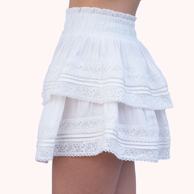 The skirt that will have you twirling through life with style. Absolute Cuteness is the must-have for the it girl who loves to play with her fashion choices. The lace trim adds a touch of flirtiness and youthful fun to a more mature style. Pair with a crop top and favorite shoe for a summer look that will turn heads. Feminine Lace Mini Skirt, Feminine Lace Mini Skirt With Lace Trim, Cotton Ruffled Mini Skirt, Feminine Fitted Mini Skirt With Gathered Details, Feminine Flowy Mini Skirt With Lace Trim, Chic Skirt With Lace Trim For Daywear, Fitted Feminine Gathered Mini Skirt, Feminine Flowy Ruffled Skirt, Chic Lace Trim Skirt For Daywear