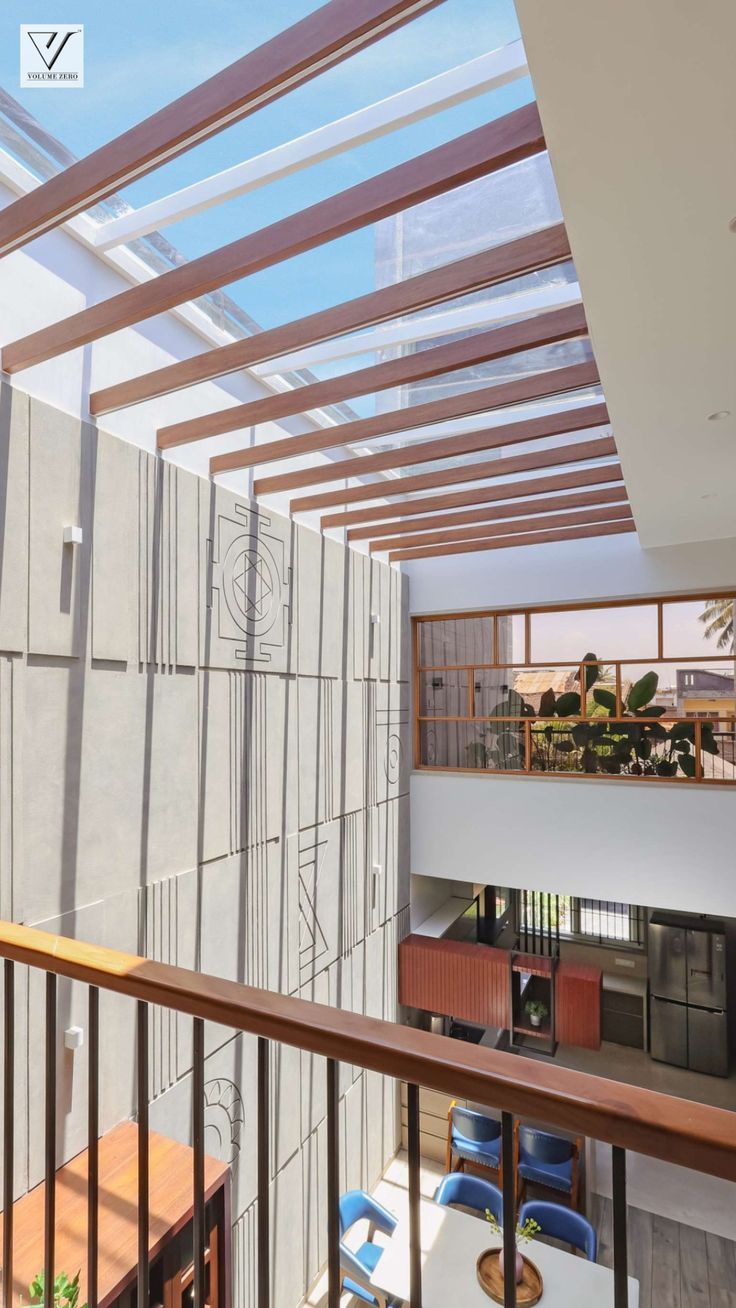 the inside of an apartment building with wood and glass on the roof, along with wooden railings