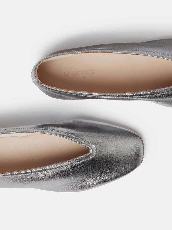 Silver leather luna slipper in supple deconstructed lambskin a cushioned calf leather insole and leather piping. 8mm heel. made in italy.    36 = 6 37=7 38=8 39=9 40=10 Elegant Calf Leather Closed Toe Slip-ons, Sleek Calf Leather Slip-on Flats, Leather Sole Slip-on Flats For Evening, Evening Slip-on Flats With Leather Sole, Evening Flats With Sculpted Heel And Almond Toe, Flat Heel Calf Leather Slip-ons, Calf Leather Slip-ons With Almond Toe, Leather Round Toe Slip-ons For Evening, Elegant Slip-ons With Leather Sole And Low Heel