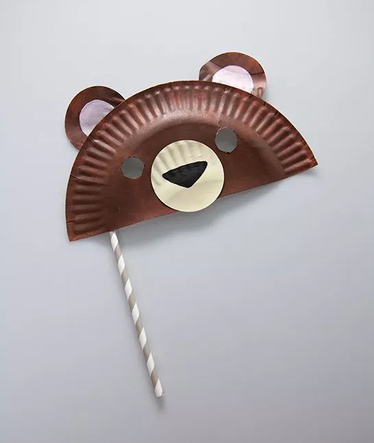 a paper plate with a bear face on it and a straw in the shape of a head