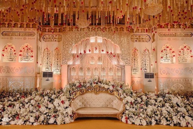 a decorated stage with flowers and chandelier