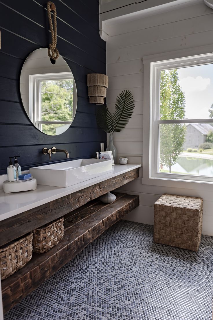 a bathroom with two sinks and a large window