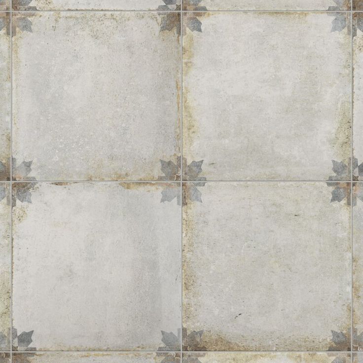 an old tile floor with grey and white flowers on the bottom, as if it were from a victorian era