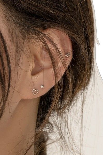 a close up of a person with ear piercings