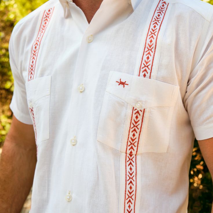 The Tejas Guayabera is the Texas Standard take on the popular south-of-the-border shirt of champions -- the guayabera. We've taken the lineage from our Standard Short Sleeve into our Tejas Guayabera, bringing along our hallmark features like a hidden button-down collar, untuckable length, and custom-cut feel, paired with the classic stylish side vents, detailed pocked embroidery, and double-breasted pocket. Our Tejas Guayaberas are made with a lightweight, breathable cotton/linen blend and are t Texas Man, Guayabera Shirt, Shirt Embroidery, University Of Texas, Leather Vest, Mens Shirt, Fishing Shirts, Pair Of Pants, Button Down Collar