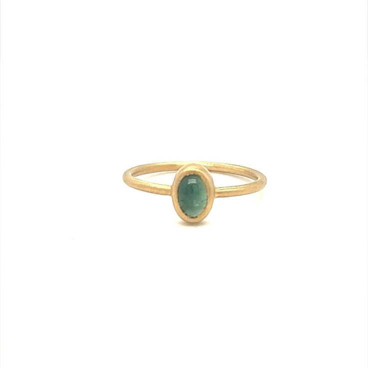 Designed and crafted by Gems Are Forever in Beverly Hills, CA, this modern classic ring features a cabochon green tourmaline set in 14K yellow gold bezel setting brushed gold. The tourmaline weighs 0.37 carat. The ring is in size 6 and can be resized. DATE OF MANUFACTURE 2022 STONE Green Tourmaline CUT Cabochon Oval WEIGHT 0.37 carat INVENTORY NUMBER 12473 METAL 14K Yellow Gold CONDITION New Oval Tourmaline Emerald Ring In Yellow Gold, Yellow Gold Emerald Ring With Oval Cabochon Bezel Setting, Yellow Gold Emerald Ring With Bezel Setting, Tourmaline Bezel-set Oval Cabochon Ring, Tourmaline Bezel Set Ring In Oval Cabochon, Tourmaline Ring With Bezel Setting In Oval Cabochon, Modern Yellow Gold Emerald Cabochon Ring, Minimalist Oval Emerald Ring With Bezel Setting, Oval Tourmaline Emerald Ring With Bezel Setting