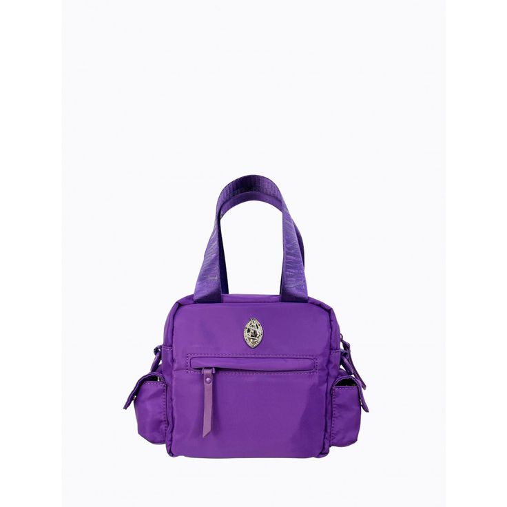 The Block Bag is made from recycled rPET fabric with matching purple powder-coated hardware, carabiner and faux leather zip pullers. With a short nylon strap and an extra adjustable long nylon strap, this bag provides versatility and can be worn on the arm, or as a cross-body bag. This bag features an internal and external zip pocket, a front two section compartment, and two side compartments to provide added practicality. * rPET fabric is made from recycled post-consumer plastics otherwise dest Nylon Tote Satchel With Detachable Strap, Nylon Satchel With Detachable Strap In Tote Shape, Nylon School Bag With Top Carry Handle, Versatile Purple Nylon Shoulder Bag, Functional Nylon Shoulder Bag With Adjustable Handle, Sporty Nylon Bag With Detachable Strap, Purple Nylon Bags, Purple Shoulder Bag With Double Handle And Zipper Closure, Nylon Satchel With Removable Pouch