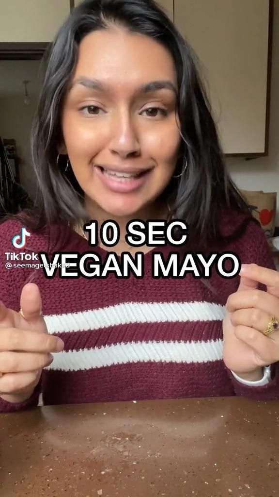 a woman is smiling and showing off her vegan mayo ring in front of the camera