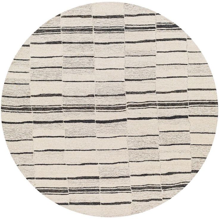 a round rug with black and white stripes