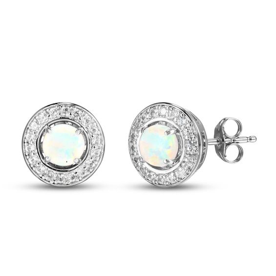 This gorgeous set showcases three lustrous pairs of stud earrings crafted in classic sterling silver. Round-cut pink, blue, and white lab-created opals glimmer in each stud. A halo of white lab-created sapphires adorn a single earring jacket, which can be worn to embellish an interchangeable pair of your choosing. The earrings secure with friction backs. Gift Diamond Earrings With Gemstones, Gift Round Diamond Earrings With Gemstones, Formal Round Diamond Earrings With Birthstone, White Diamond Birthstone Earrings, White Cubic Zirconia Birthstone Earrings, Classic White Birthstone Earrings, Formal White Earrings With Round Stones, Formal White Round Stone Earrings, Formal White Earrings