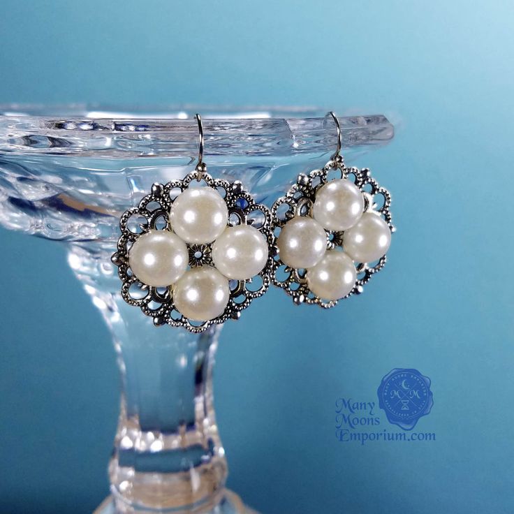 Dowager Queen Elizabeth Woodville Pearl Earrings in Antique Bronze Introducing the Dowager Queen Elizabeth Woodville earrings inspired by the beautiful pearl girdle belt worn by Essie Davis in the Starz miniseries "The White Princess". The Elizabeth Woodville earrings were designed as a companion piece to the pearl girdle belt. These lightweight earrings mirror the belts swirling antique silver filigree stations set with pearl gem quartets on a slightly smaller scale. Wear the earrings alone or Silver Hypoallergenic Pearl Earrings For Party, Hypoallergenic Silver Pearl Earrings For Party, Silver Victorian Pearl Earrings For Anniversary, Silver Jewelry With Pearl Buttons As Gift, Victorian Silver Pearl Earrings For Anniversary, Vintage Silver Pearl Earrings For Party, Nickel-free Silver Pearl Earrings For Party, Vintage Nickel-free Pearl Earrings For Wedding, Victorian Silver Pearl Drop Earrings