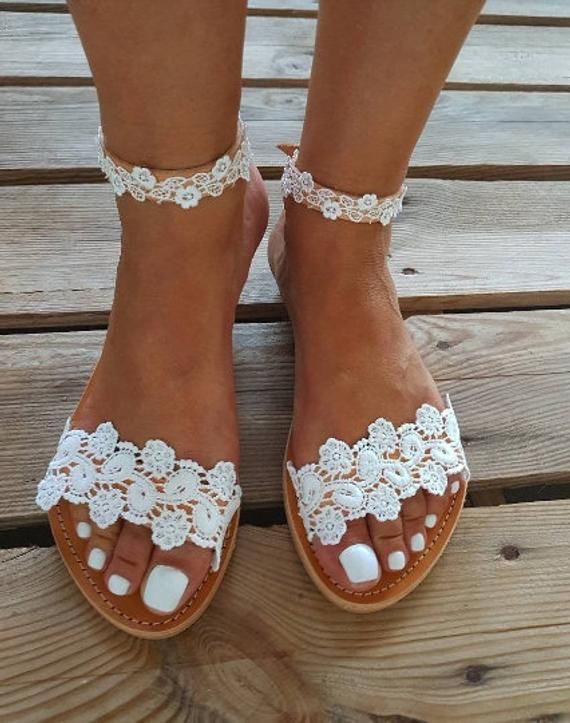 SHIPPING via DHL EXPRESS WORLDWIDE: 1 - 4 business days delivery (Please fill in your phone number if you choose Express Shipping) ★ More wedding sandals and shoes: See my store: https://www.etsy.com/shop/PelinoSandals 💓 Handmade genuine Greek leather wedding sandals decorated with romantic lace or crystals,pearls,rhinestones ( all the embellishments are hand sewn onto the leather straps) for brides dreaming of a beach wedding, a Bachelor party or even a city wedding. I am here to create with y White Flat Lace-up Beach Sandals, White Flat Lace-up Sandals For Beach, White Lace-up Summer Sandals With Round Toe, White Flat Heel Lace-up Sandals For Beach, White Round Toe Lace-up Summer Sandals, Spring Beach Wedding Closed Toe Shoes, Elegant Handmade Beach Sandals, Summer Toe Ring Sandals With Flat Heel, White Closed Toe Lace-up Beach Sandals