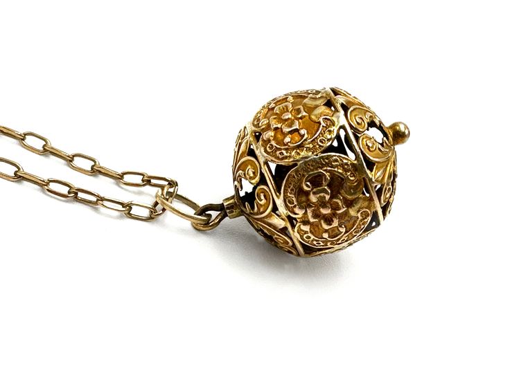 "Unusual 21-inch antique necklace: a 10k pierced ornate filigree globe pendant on an antique 8ct chain. The jump link was added later but it's antique and marked 14k. The vintage gold-filled clasp is a replacement. Measurements: 5/8\" wide x 1 1/16\" high Weight: 5.41g NEC.INS_0004.23 FREE DOMESTIC STANDARD SHIPPING Another Sky Vintage Home Page https://www.etsy.com/shop/AnotherSkyVintageLLC?ref=hdr_shop_menu PA residents will have 6% sales tax added where applicable. Other states charge taxes on online purchases as well. Buyers will find these are added to the bill automatically by Etsy, wherever they apply. INTERNATIONAL SHIPPING: Dear international buyer, please be aware of Customs laws and duties and import taxes in your country so as to be prepared for Customs charges where they apply Heirloom Pendant Necklace With Intricate Design, Traditional 14k Gold Necklace With Intricate Design, Ornate Vintage Charm Round Pendant Jewelry, Ornate Vintage Charm Pendant Jewelry, Vintage Filigree Pendant Jewelry, Ornate Pendant Jewelry With Vintage Charm, Formal Necklace With Vintage Charm And Round Pendant, Antique Gold Heirloom Necklace For Formal Occasions, Formal Vintage Charm Necklace With Round Pendant