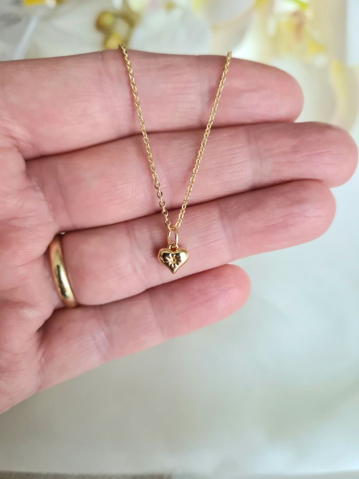 ❤Beautiful 18K Gold plated heart pendant necklace. ❤The tiny 18K Gold plated heart is just 7mm x 7mm engraved with a little star shape. ❤The strong long lasting 18K Gold plated link chain is 1.6mm in diameter and 17 inches in length plus a 2 inch extender chain with lobster clasp closure. ❤Hypoallergenic and perfect for everyday wear or special occasion.  ❤A really cute pendant necklace that will make a beautiful gift for that someone special. It will arrive in a lovely velvet pouch ready for gi Dainty Personalized Small Charm Necklaces, Dainty Personalized Small Charm Necklace, Hypoallergenic Gold-plated Necklace For Anniversary, Hypoallergenic Gold Plated Necklace For Anniversary, Hypoallergenic Gold Plated Necklace For Gift, Dainty Gold Plated Charm Necklaces Tarnish Resistant, Gold Plated Charm Necklaces With Delicate Chain For Anniversary, Gold Charm Necklace With Delicate Chain For Valentine's Day, Dainty Gold Plated Charm Necklace, Tarnish Resistant