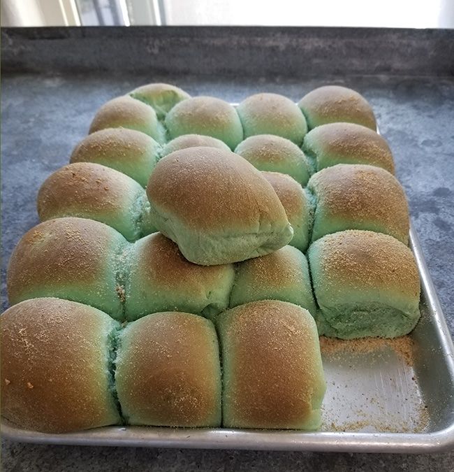 a pan filled with rolls sitting on top of a counter