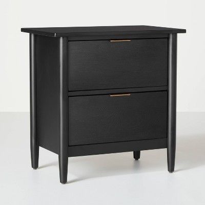 a black nightstand with two drawers sitting on top of it