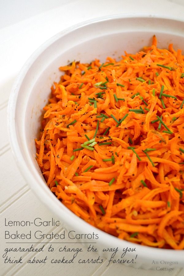 a white bowl filled with cooked carrots on top of a table