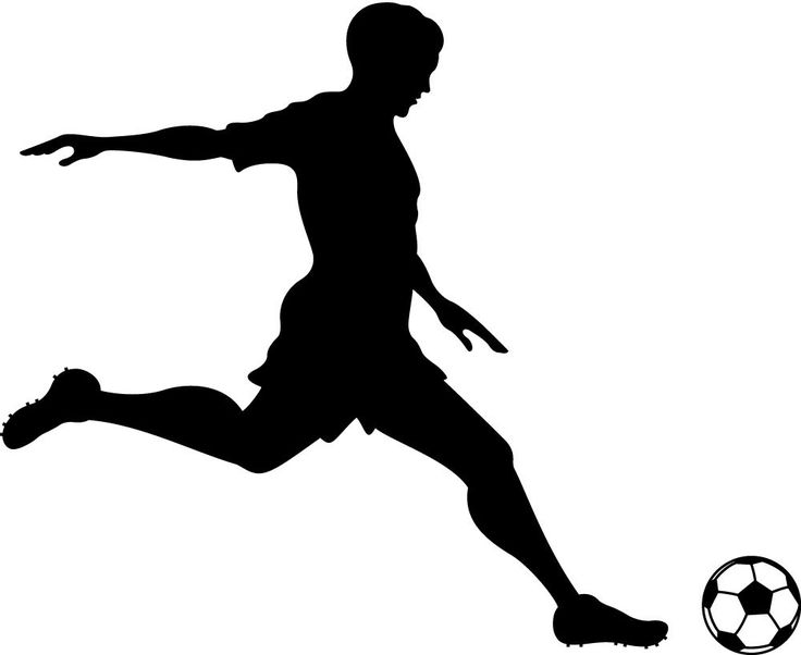 a silhouette of a soccer player kicking the ball with his foot in mid - air