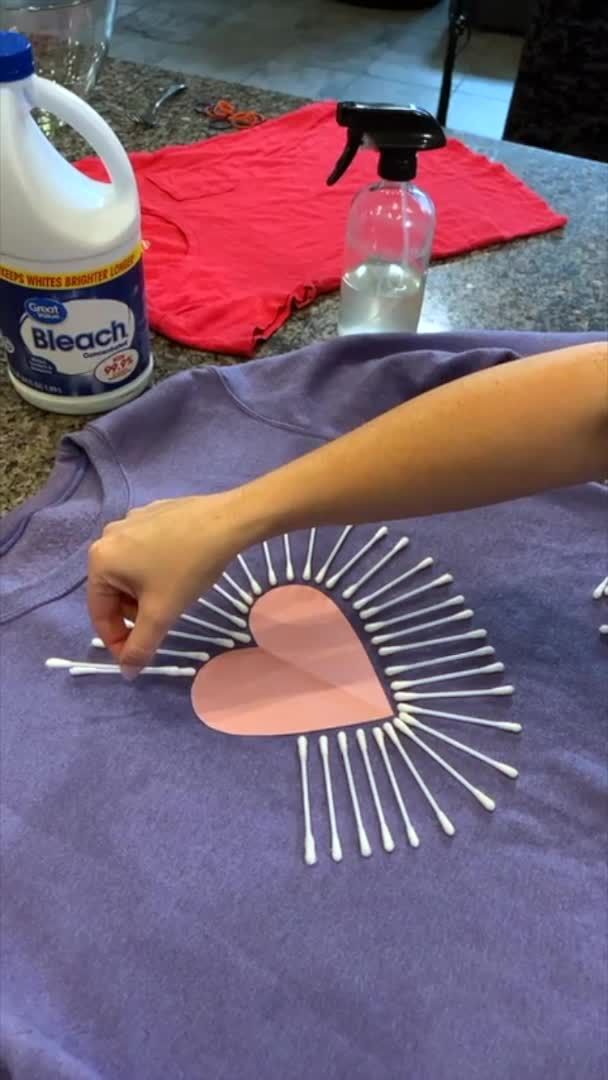 someone is making a t - shirt with sunbursts on it and glue