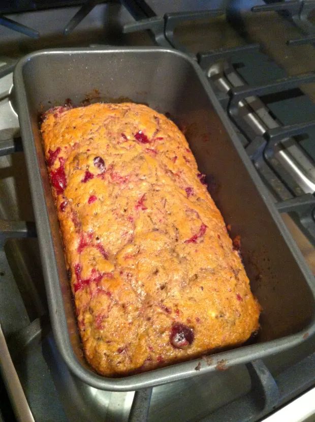 a loaf of fruit cake sitting in a pan on top of an oven burner