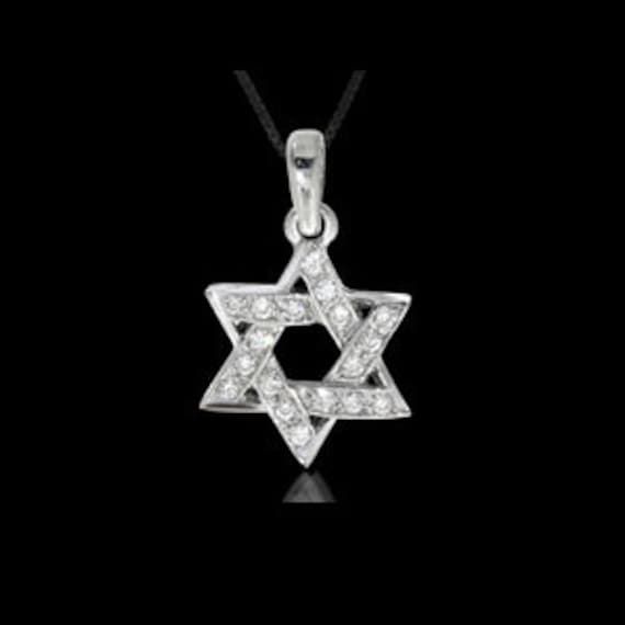 Star of David gold & diamonds pendant, made of white gold 14k and diamonds. Judaica pendant for Bar Mizva present. Gemstone: Small Diamonds - 18 pcs. 0.15 carats Available gemstones:  Diamond Metal: White Gold 14k Available metals:  White Gold 18k, White Gold 14k, Yellow Gold 14k, Yellow Gold 18k Weight: 1.30 gram Catalog code: PH-1231w Free shipping 1-3 business days shipping White Gold Diamond Necklace Star Of David Gift, Luxury White Gold Star Of David Jewelry, Luxury Diamond Necklace In Star Of David Shape, Silver Star Of David Fine Necklace, White Gold Diamond Necklace Star Of David Shape, White Gold Diamond Necklace With Star Of David, White Gold Diamond Necklace In Star Of David Shape, Diamond White Star Of David Jewelry Gift, Diamond Necklace With Star Of David Charm For Gift