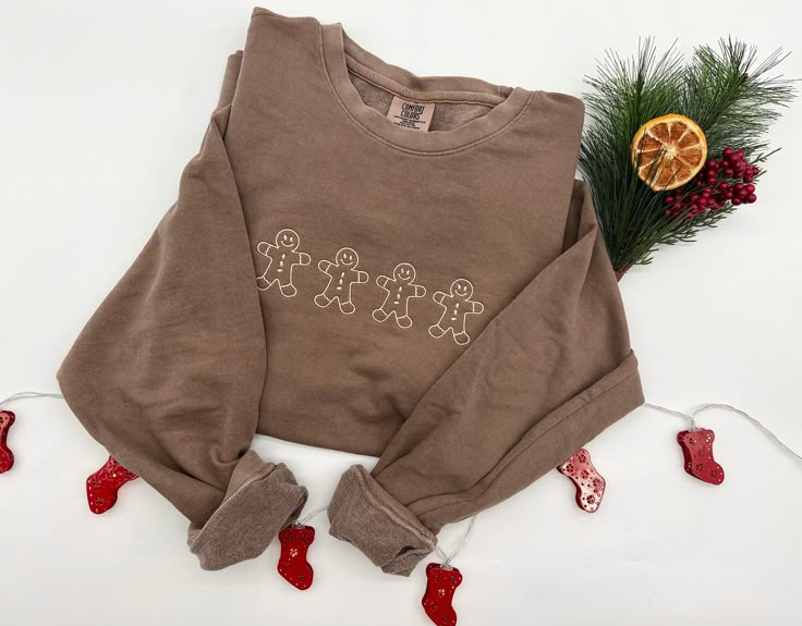 "GINGERBREAD MEN EMBROIDERED CREW NECK SWEATSHIRTS! This is the perfect gift for this holiday season.  I M P O R T A NT .  P L E A S E . R E A D . C A R E F U L L Y ---------------------------------------------------------------------------- { D E T A I L S } The Sweatshirts are Light Weight Comfort Colors Crewnecks:  - Garment-dyed for that lived in feel and almost no shrinkage at home. - Soft ring spun cotton fabric with 100% cotton threads - Relaxed fit - 1x1 rib collar, cuffs and waistband - Rolled forward shoulder - Back neck tape  T I M E ∙ T O ∙ D E L I V E R Y : -->Processing & production time is 3-5 days. -->Delivery time varies depending on your delivery address. E M B R O I D E R Y . O R D E R . I N S T R U C T I O N S Embroidery length is 8\".  Embroidery height is 2.5\".  Cust Christmas Embroidery Sweatshirts, Cute Embroidered Sweatshirt, Embroidered Christmas Sweatshirt, Christmas Sweatshirts Vinyl, Embroider Sweatshirts, Sweatshirt And Shirt Outfit, Christmas Sweatshirt Ideas, Xmas Clothes, Xmas Sweaters