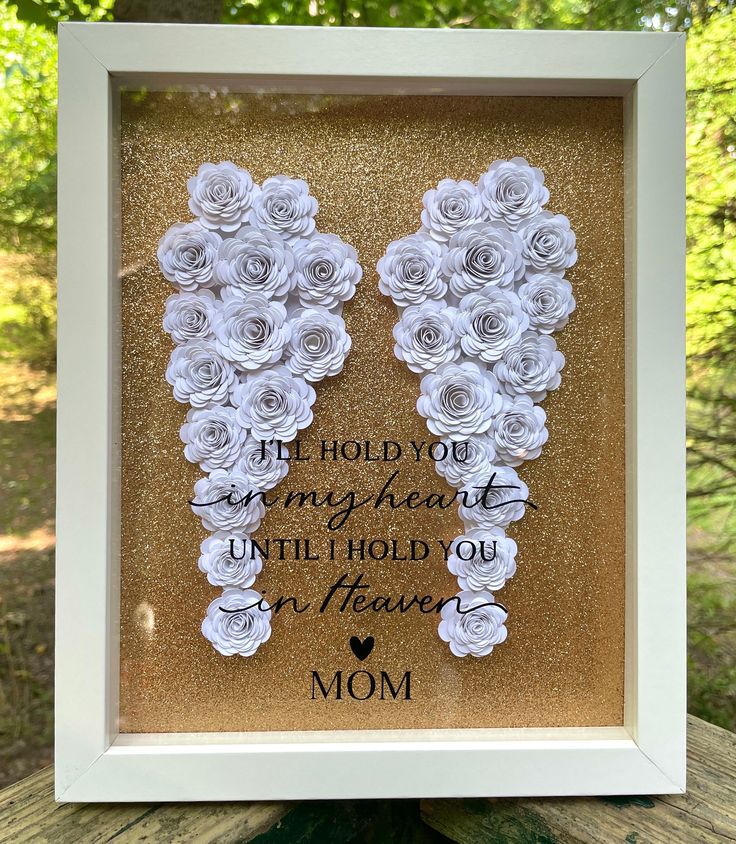 a framed photo with flowers and the words, i hold you in my heart