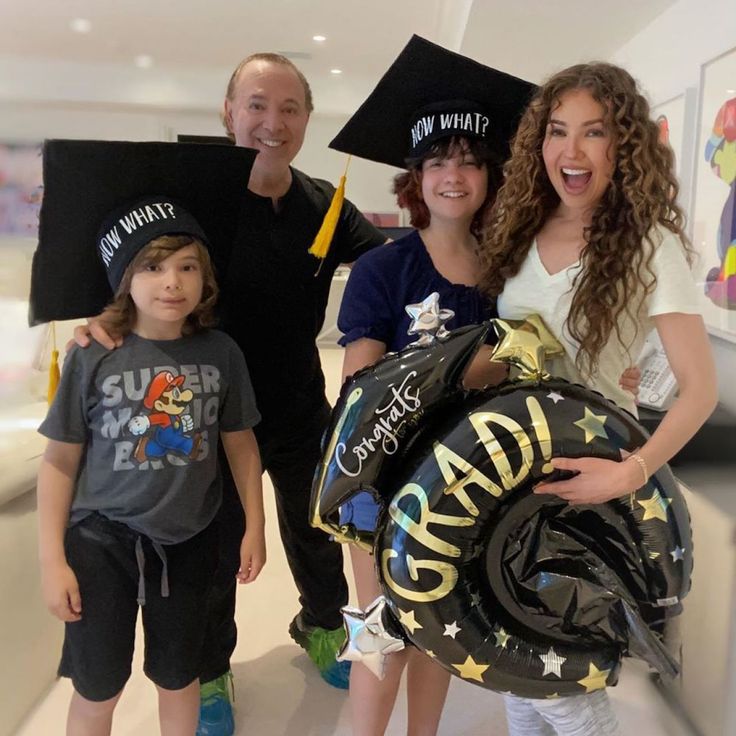 a family poses for a photo while wearing graduation caps