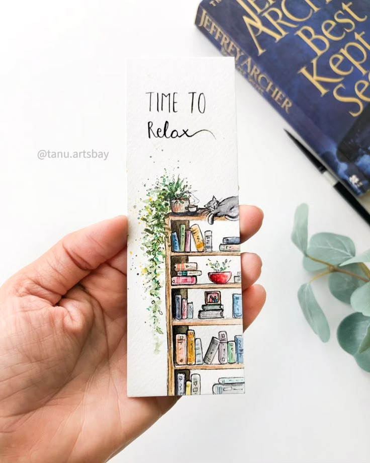 a hand holding up a bookmark that says time to relax with books in the background