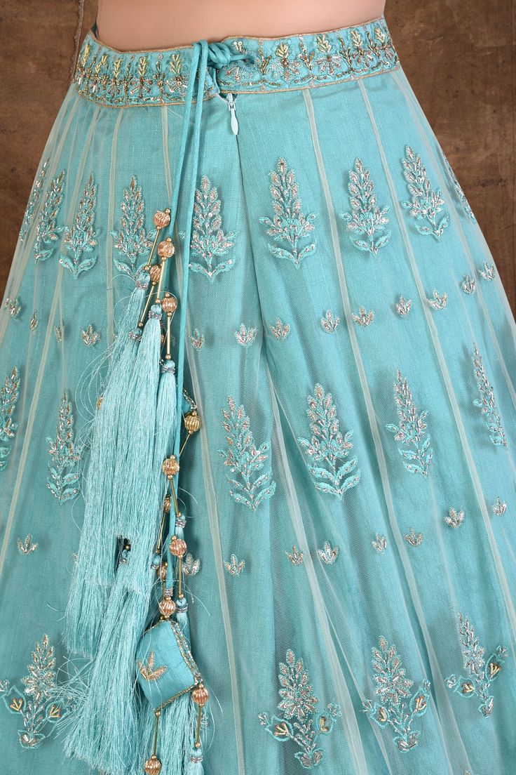 Turquoise blue lehenga with all over thread and dabka work. Comes with embroidered blouse and dupatta.
Components:3
Thread, sequin, dabka embroidered
Neckline:Sweetheart
Sleeve Length:Half
Fabric:Blouse and Lehenga: Net, dupion; Dupatta: Net
Color:Blue
Cutout sheer back
Tassel detail
Laced dupatta
Lining fabric: tafetta and malmal
Closure: Blouse: Side zip
Lehenga: Hook button, side zip and tie-up - Aza Fashions Festive Blue Sharara With Intricate Embroidery, Designer Turquoise Sets With Resham Embroidery, Blue Intricate Embroidered Anarkali Set For Wedding, Blue Anarkali Lehenga With Intricate Embroidery, Blue Intricate Embroidery Anarkali Set For Wedding, Blue Embroidered Anarkali Set For Wedding, Blue Bollywood Anarkali Set With Intricate Embroidery, Bollywood Blue Anarkali Set With Intricate Embroidery, Blue Anarkali Set With Intricate Embroidery For Wedding