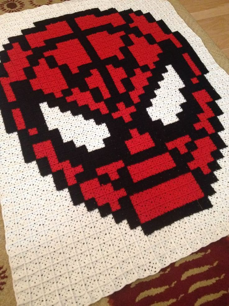 a close up of a knitted deadpool blanket