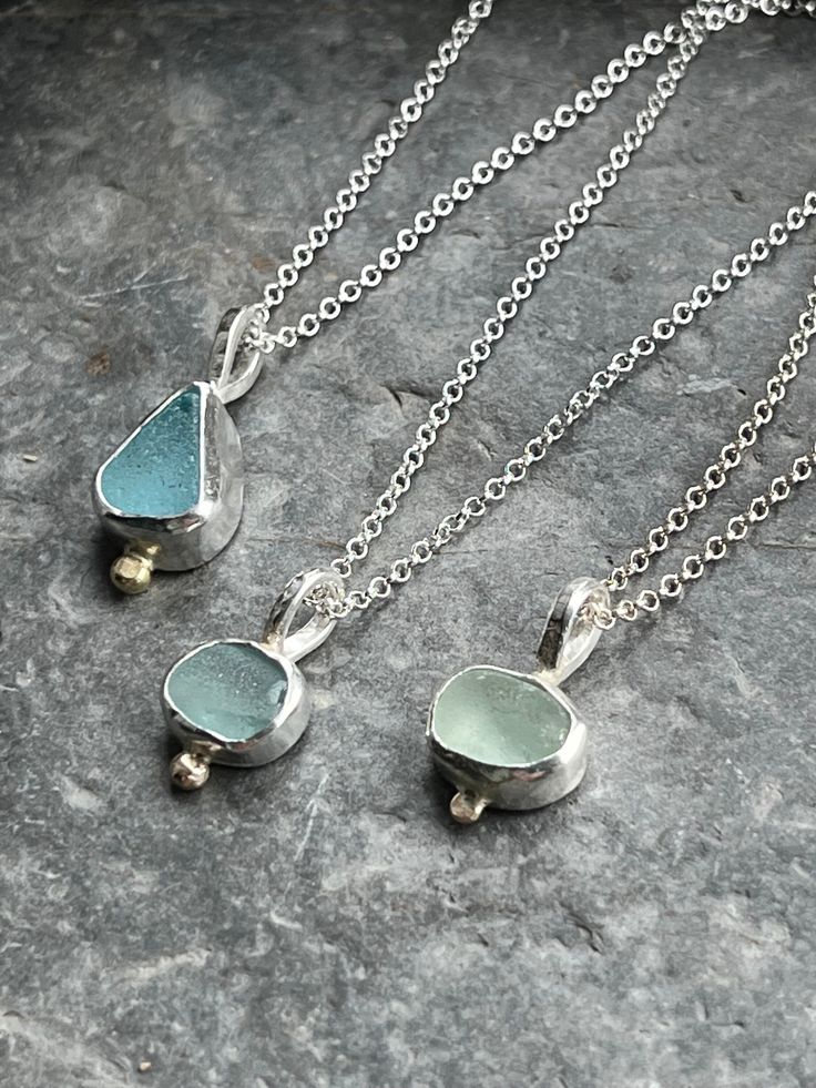 Beautiful, small pieces of sea glass, found on beaches local to me around Fowey on the south coast of Cornwall, are set in a purpose made sterling and fine silver bezel, with a little nugget of recycled 9ct gold, and suspended on your choice of 16"/40cm, 18"/45cm, or 20"/50cm chain. The sea glass pieces are approximately 0.7cm to 1cm. All of my silver jewellery is beautifully wrapped and boxed in my branded packaging :) Seaglass Necklace, Jewellery Necklaces, Branded Packaging, Glass Jewellery, Sea Glass Pendant, Glass Pieces, Sea Glass Necklace, Necklaces For Women, Sea Glass Jewelry