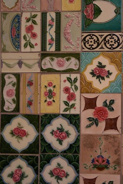 some very pretty tiles with flowers and leaves on them, all in different shapes and sizes