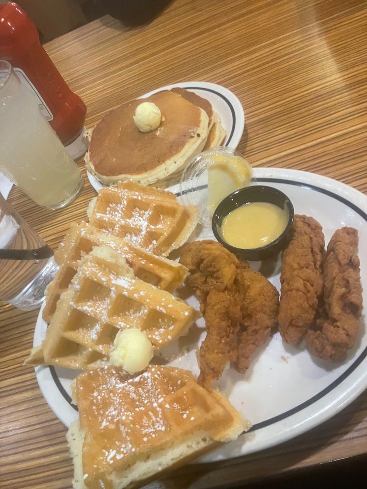 a white plate topped with waffles and other foods