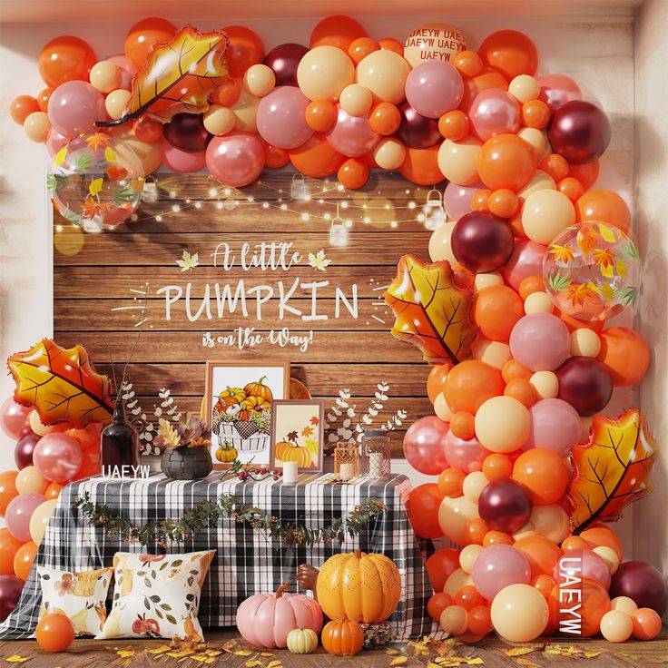 an arrangement of balloons and decorations for a fall themed party