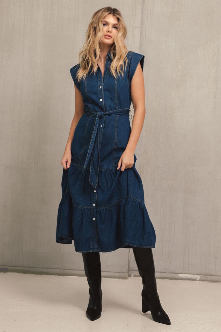 The Daria dress is a versatile denim dream featuring cap sleeves, a button-up front, and tiered bottom. Lightweight fabric, contrast stitching, and a belted waist create a flattering silhouette in black or blue. Moody Closet, Dallas Outfits, Denim Dress Fall, Jumpsuit Coverup, Fall Bottoms, Late Summer Early Fall, Jumpsuit Fall, Outfit Planning, Jumpsuit Summer