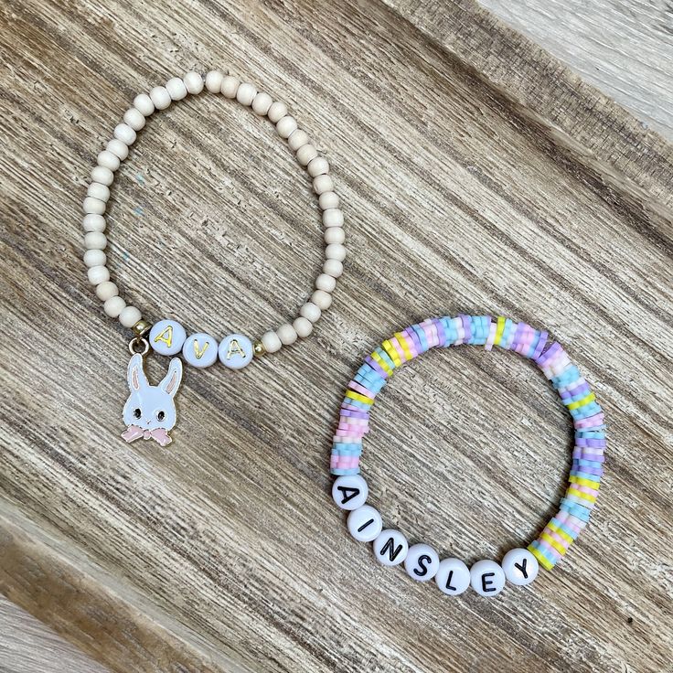 Handmade kids beaded bracelets for Easter! These are such a cute gift idea for your littles or any littles you may know! You may choose to purchase the stack or an individual bracelet.   1. 6mm flower pastel multicolor heishi name bracelet with black/white letter beads 2. 4mm wood bead & gold bunny bracelet with gold/white letter beads- bunny bow can be pink or blue  3. 6mm iridescent pastel color glass beaded bracelet with clay bunny These are made in kids size and will be 5.5in. If you are needed to resize, please send me a message as soon as you purchase.  Heishi beads are small and may present a choking hazard for children under the age of 4. Please monitor your child at all times when they are wearing these bracelets to prevent them from putting the bracelet in their mouth. Playful Personalized Beaded Bracelets For Gifts, Playful Adjustable Bracelets For Personalized Gift, Playful Customized Bracelets For Gifts, Customized Playful Adjustable Name Bracelet, Cute Adjustable Beaded Bracelets With Custom Name, Playful Adjustable Customized Name Bracelet, Adjustable Custom Name Bracelets For Party Favors, Customized Playful Name Bracelet Adjustable, Playful Customized Adjustable Name Bracelet