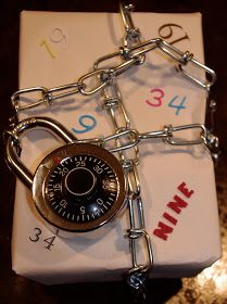 a gift wrapped in white paper with a lock and chain attached to the present box