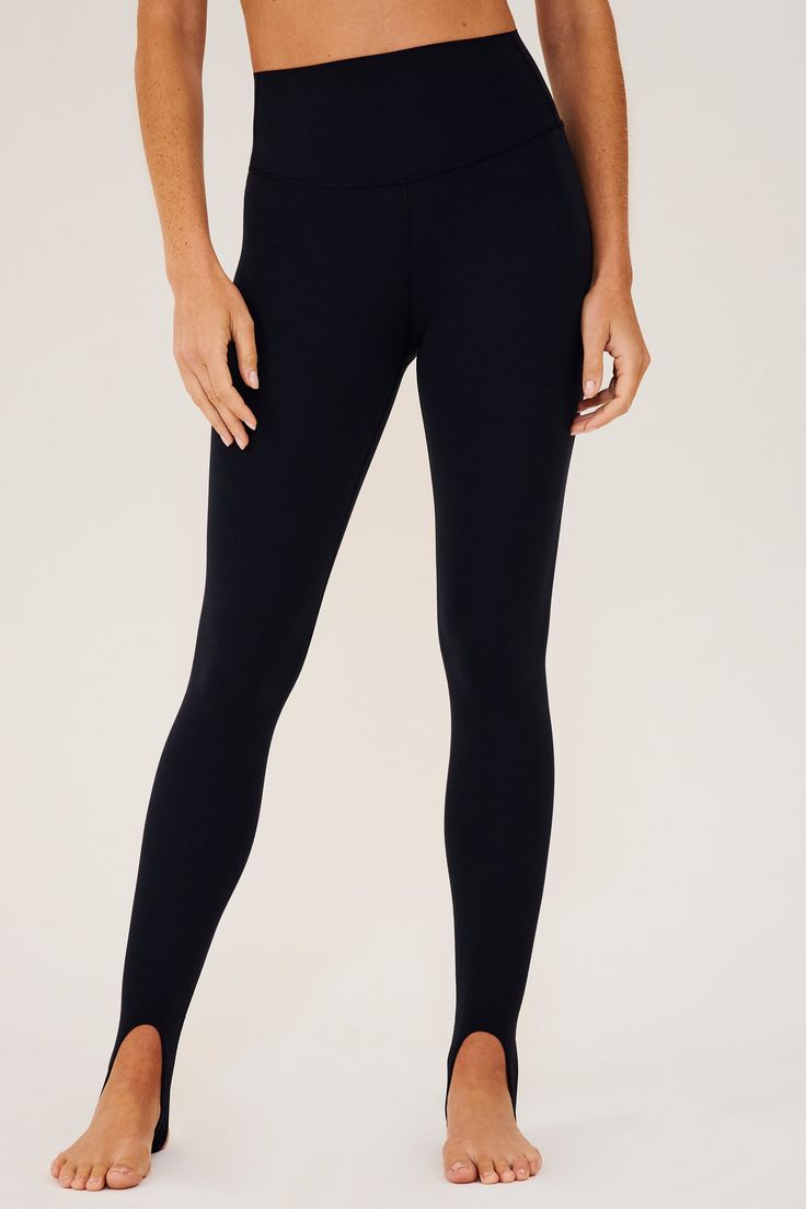 Our famous, form fitting high waist legging redesigned as a stirrup tight. Our ultra luxe Airweight fabric has a supremely soft hand and second skin comfort. BEST FOR: hot yoga, barre, Pilates. Model is 5'10" and wears a size small. Micro-elastic Black Yoga Pants, High Stretch Sleek Sports Tights, Sleek Compressive Leggings For Pilates, Micro-elastic Black Yoga Bottoms, Sleek Sports Tights With High Stretch, Sleek High Stretch Sports Tights, Sleek High-stretch Sports Tights, Sleek Fitted Sports Tights, Sleek Yoga Tights