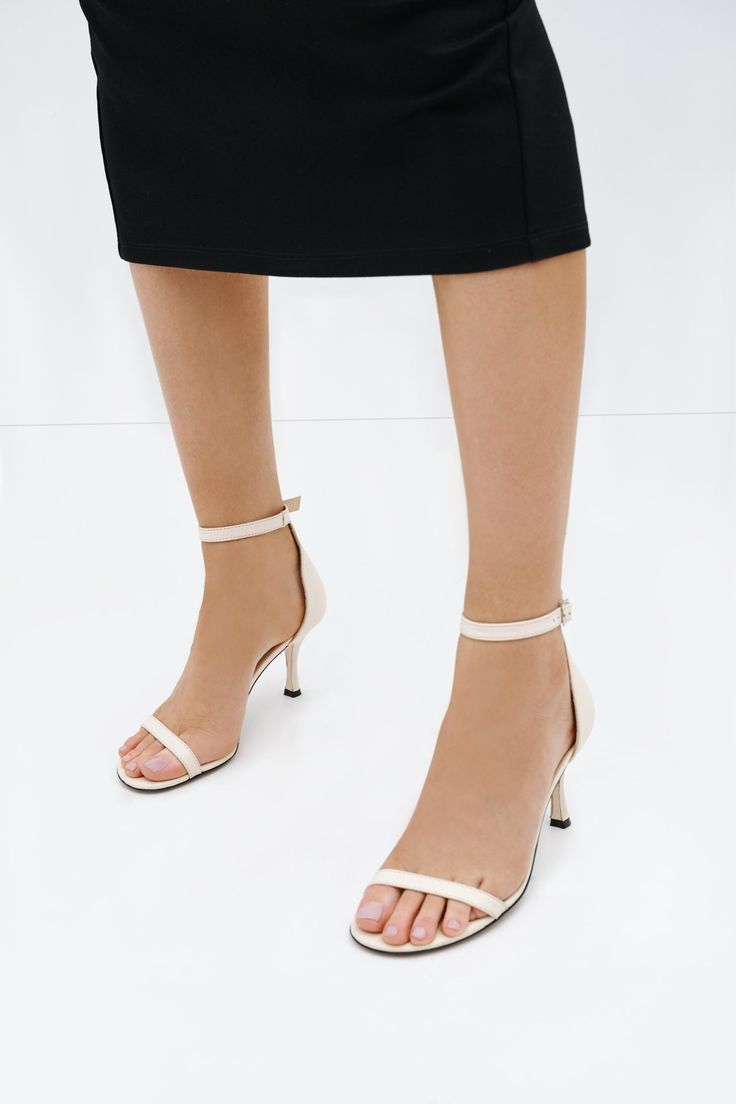 Our Petra Sandals are the perfect example of when less is more. In Italian leather, these round-toe cocktail sandals feature a slender toe strap and an adjustable buckled ankle strap for a clean, minimalist aesthetic. The skinny spool heel gives an elegant lift—and we've added extra padding so they're comfortable for all day wear, too.[SPLIT] Maritza wears Petra in black, in cream, in disco, in spring green, and in hot pink. Heel height is approximately 3" (8 cm). Sold in US sizes, though please Elegant Ankle Strap Sandals With Adjustable Strap, Elegant Heels With Ankle Strap, Elegant Heels With Adjustable Ankle Strap, Spring Sandals With Single Ankle Strap, Spring Sandals With Ankle Strap And Single Strap, Spring Ankle Strap Sandals With Single Strap, Formal Single Strap Sandals For Spring, Spring Formal Single Strap Sandals, Summer Ankle Strap Sandals With Penny Strap