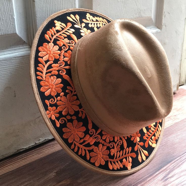 Stand out with this beautiful handcrafted Mexican Suede Hat with beautiful detailed floral embroidered canvas brim. Perfect accessory to add that with that daily outfit. MADE IN MEXICO By: Mexican Artisans For: Women Size: Medium 23' Color: tan | black | orange Details: Top Suede Embroidered canvas brim Inner elastic band Contact us for more details PLEASE READ BEFORE PURCHASE: The picture is an ACCURATE REPRESENTATION.Colors in the pictures may vary a little by effects of light. Each product is Embroidered Brimmed Spring Hats, Spring Embroidered Brimmed Hat, Spring Embroidered Flat Brim Hat, Traditional Flat Brim Hat, Brown Embroidered Hat, One Size, Traditional Wide Brim Hat For Spring, Traditional Adjustable Brimmed Felt Hat, Embroidered Fedora Hat For Festivals, Festival Embroidered Fedora Hat