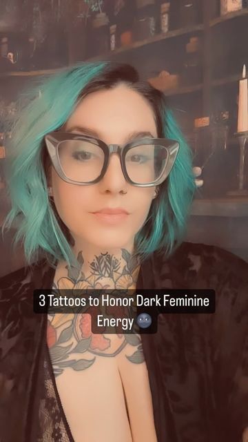 a woman with green hair wearing glasses and tattoos