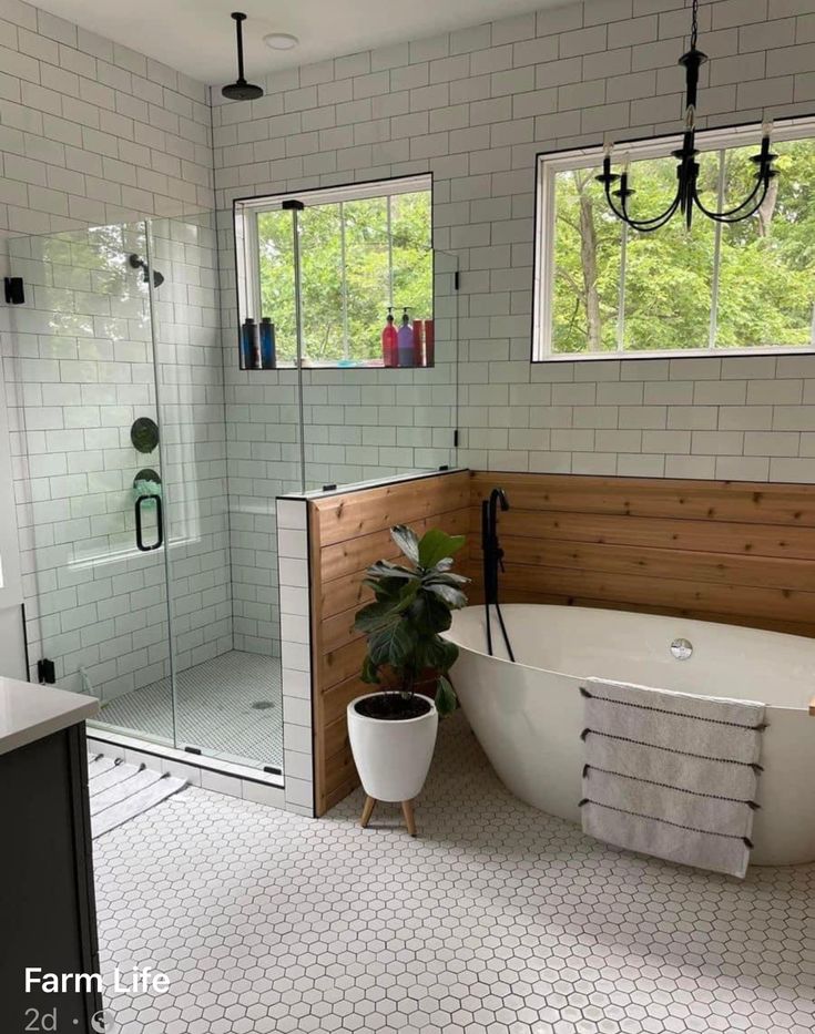 a bathroom with a tub, sink and shower in it's own area is shown