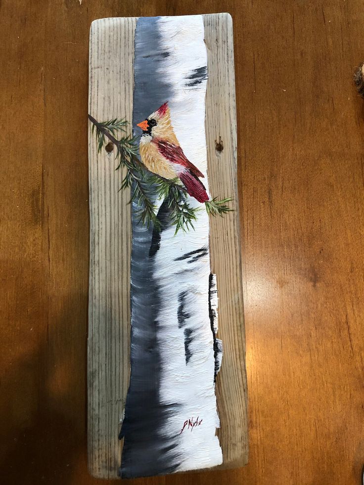 a painting of a bird sitting on top of a piece of wood with pine branches